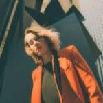 woman in orange suit jacket